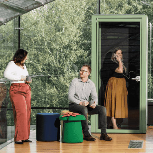 hoozone telephone booth in orange with modular seating outside, collaborative office area