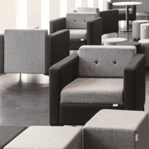 Tornado Arm chair with grey fabric with black arms,