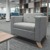 Grey Tornado arm chair with wooden legs and buttoned back
