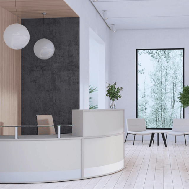corner curved receptiv reception desk with ball pendant lights and lounge seating in waiting area