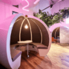 close up shot of escape office pod with pink led lighting curved pod design