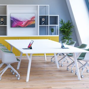 angled Y Leg meeting table in white shown in an office with cube storage and meeting chairs