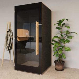 Hide booth in black shown next to a plant with door closes