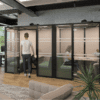 Era Hoozone Jimmy Working Pod office acoustics for meetings in grey with lined front manifestations four person enclosed pod with fabric back in green and pink fabric with LED lighting