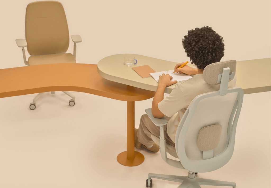 Person sitting comfortably in an ergonomic office chair with correct posture, feet flat on the floor and knees at a right angle