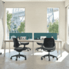 edit office ux mesh chairs in black with desk in an office environment with blue screens