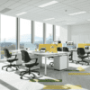 multiple edit office ux mesh chairs in green with multiple desks in an office environment