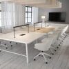 Serenity small meeting tables in white and oak surrounded by office chairs in a meeting room
