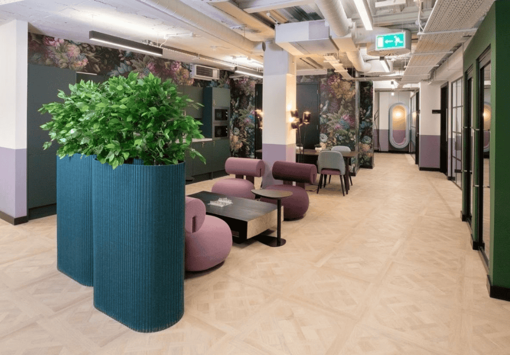 Tall modular planters creating natural divisions between open-plan workstations.