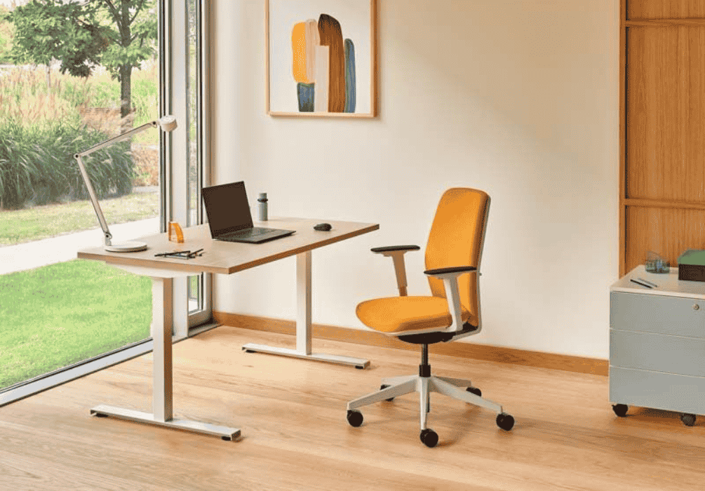 Home office with height-adjustable desk and ergonomic chair for healthy working posture
