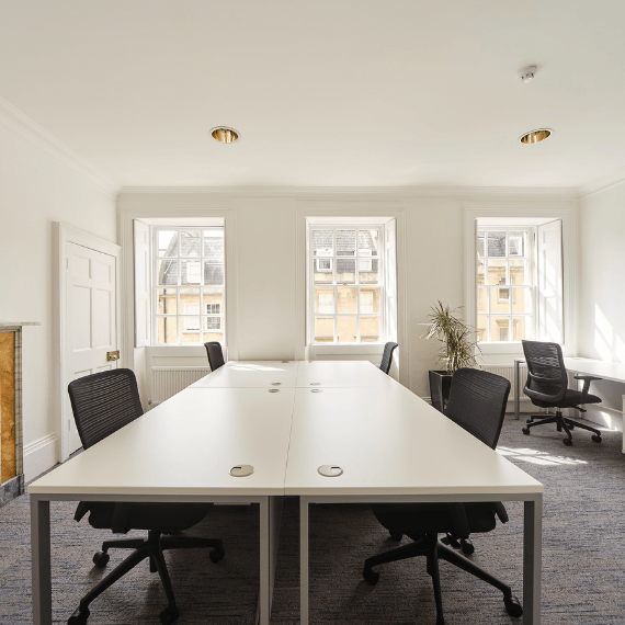 Modern 6-person office layout with white desks and black mesh chairs at HPH Commercial Property, South West