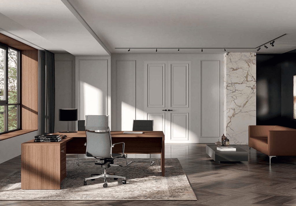 High back executive office chair with leather upholstery positioned behind a director’s desk in a professional office..