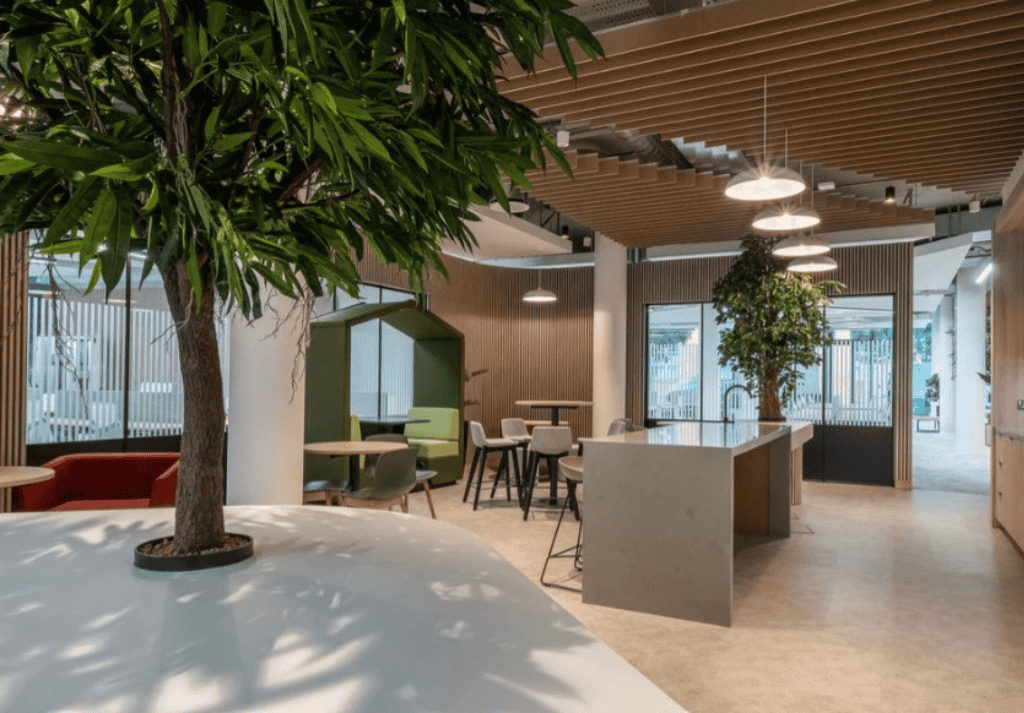 Office breakout area with vertical moss wall, planters, and integrated lighting