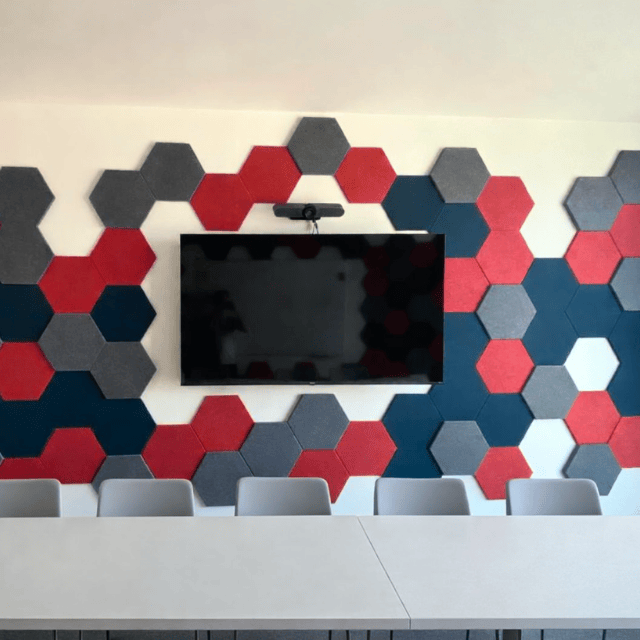 Finished Solar Edge meeting room with acoustic wall panels installed, neatly integrated around wall-mounted TV for a modern office fit out