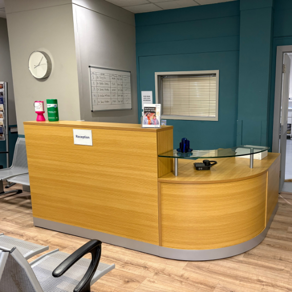 Modern reception area design for film studio environment showcasing bespoke reception desk and adaptable workspace planning