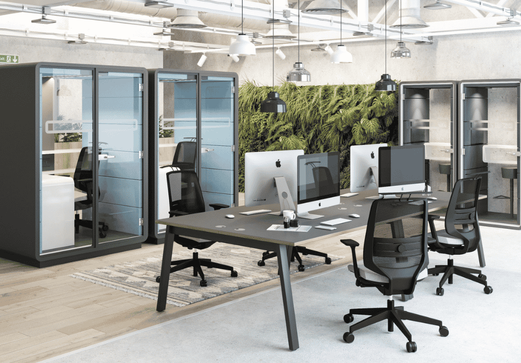 Modern open plan office with bench desks, employees working collaboratively in a bright, ergonomic workspace with natural lighting