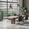Italian-designed X10 executive meeting table with sculptural curved base in a contemporary boardroom featuring luxury executive office furniture.