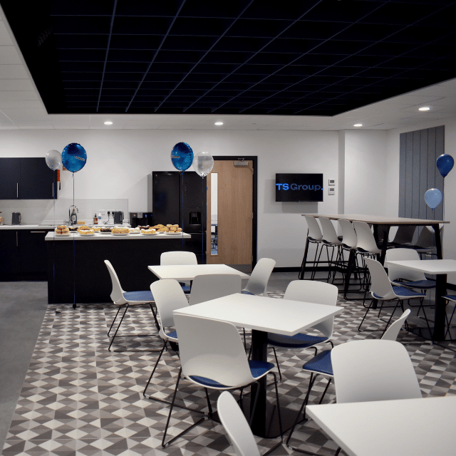 Employees collaborating within a modern commercial office fit-out featuring acoustic design, open-plan workspaces and contemporary office furniture.